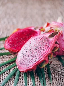 pink-pitahaya-dragon-fruit-with-palm-leaves-rattan-background-copy-space-creative-design-banner-summer-time-tropical-travel-exotic-fruit-vegan-vegetarian-concept_769609-3730